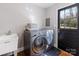 Laundry room with washer, dryer, sink, and access to the exterior of the home at 1116 Circlewood Dr, Charlotte, NC 28211