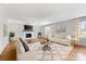 Staged living room features a cozy fireplace, neutral paint, hardwood floors, and ample natural light at 1116 Circlewood Dr, Charlotte, NC 28211