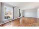 Bright living room with large windows and hardwood floors, offering a spacious and airy atmosphere at 1116 Circlewood Dr, Charlotte, NC 28211