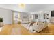 Spacious living room with wood floors, wainscoting and large windows, plus built-in shelving at 1116 Circlewood Dr, Charlotte, NC 28211