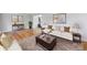Staged living room features a beige rug, hardwood floors, comfortable sofa, and stylish décor at 1116 Circlewood Dr, Charlotte, NC 28211