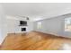 Neutral living room features a cozy fireplace, neutral paint, hardwood floors, and ample natural light at 1116 Circlewood Dr, Charlotte, NC 28211