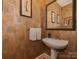 Stylish powder room with pedestal sink and decorative wallpaper at 11756 Easthampton Cir, Charlotte, NC 28277