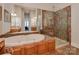 Spa-like bathroom with soaking tub, walk-in shower, and double vanity at 11756 Easthampton Cir, Charlotte, NC 28277