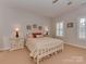 Bedroom with white wooden bed frame and beige carpet at 11756 Easthampton Cir, Charlotte, NC 28277