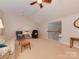 Spacious bonus room featuring a seating area and access to upper level at 11756 Easthampton Cir, Charlotte, NC 28277