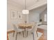Cozy dining area with modern lighting, neutral decor, and hardwood floors at 11756 Easthampton Cir, Charlotte, NC 28277