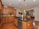 Modern kitchen with large island, granite countertops, and stainless steel appliances at 11756 Easthampton Cir, Charlotte, NC 28277