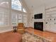 Bright living room with a fireplace, large windows, and hardwood floors at 11756 Easthampton Cir, Charlotte, NC 28277