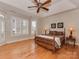 Main bedroom with hardwood floors, a ceiling fan, and ample natural light at 11756 Easthampton Cir, Charlotte, NC 28277