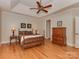 Main bedroom with hardwood floors, a ceiling fan, and an ensuite bathroom at 11756 Easthampton Cir, Charlotte, NC 28277