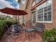 Brick patio with metal furniture and umbrella, ideal for outdoor relaxation at 11756 Easthampton Cir, Charlotte, NC 28277