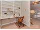 Built-in shelving and a wooden desk create a home office at 11756 Easthampton Cir, Charlotte, NC 28277