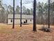 Home's backyard is surrounded by tall trees with a deck at 1194 Great Falls Hwy, Chester, SC 29706