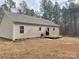 Home's back features a deck, wooded area, and spacious yard at 1194 Great Falls Hwy, Chester, SC 29706