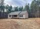 Newly built house with light beige vinyl siding, gray roof, and small front porch at 1194 Great Falls Hwy, Chester, SC 29706