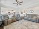 Bright living room with gray leather sectional and hardwood floors at 12612 Es Draper Dr, Huntersville, NC 28078