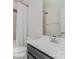 Bathroom featuring a shower with tile surround, white sink and vanity, and white toilet at 1419 Newell Towns Ln, Charlotte, NC 28262