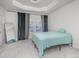 Bright bedroom with a tray ceiling, large window, and modern decor at 1419 Newell Towns Ln, Charlotte, NC 28262