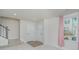 Bright entryway featuring neutral walls, gray carpeted stairs, and a window with natural light at 1419 Newell Towns Ln, Charlotte, NC 28262