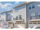 Exterior view of modern gray townhomes, each with its own private deck and garage at 1419 Newell Towns Ln, Charlotte, NC 28262