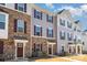 Well-maintained townhome exterior showing a mix of stone and siding with a manicured lawn at 1419 Newell Towns Ln, Charlotte, NC 28262