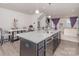 Modern kitchen featuring a spacious island with seating and granite countertops at 1419 Newell Towns Ln, Charlotte, NC 28262