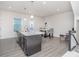 Bright kitchen features a large island with granite countertops and modern pendant lighting at 1419 Newell Towns Ln, Charlotte, NC 28262