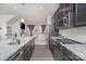 Modern kitchen featuring sleek dark cabinets, granite countertops, and stainless steel appliances at 1419 Newell Towns Ln, Charlotte, NC 28262