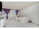Bright living room with neutral walls, plush carpeting, and a comfortable, light colored sofa at 1419 Newell Towns Ln, Charlotte, NC 28262