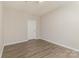 A minimalist bedroom showcasing wood flooring and a door at 14967 Santa Lucia Dr, Charlotte, NC 28277