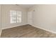 Cozy bedroom featuring a window for natural light and wood-look floors at 14967 Santa Lucia Dr, Charlotte, NC 28277