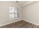 Simple bedroom with wood floors and a window letting in natural light at 14967 Santa Lucia Dr, Charlotte, NC 28277