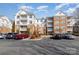 Multi-story condo building featuring multiple balconies and ample parking at 14967 Santa Lucia Dr, Charlotte, NC 28277