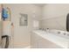 Functional laundry room features a washer, dryer, water heater, and shelving for easy organization and convenience at 14967 Santa Lucia Dr, Charlotte, NC 28277