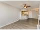 Open living space featuring wood floors, a ceiling fan, and seamless flow to kitchen at 14967 Santa Lucia Dr, Charlotte, NC 28277