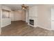 Open-concept living room with a fireplace, wood floors, and neutral color scheme at 14967 Santa Lucia Dr, Charlotte, NC 28277