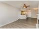 Open living room with wood flooring, bright natural light, and a kitchen with a granite breakfast bar at 14967 Santa Lucia Dr, Charlotte, NC 28277