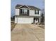 Two-story house with a white and gray exterior, a double garage, and landscaping at 155 Trail Wood Ct, Salisbury, NC 28146