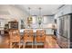 Modern kitchen featuring an island with seating, stainless steel appliances, and pendant lighting at 166 S Smallwood Pl, Charlotte, NC 28208