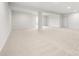 Spacious finished basement with neutral carpeting and sliding glass doors at 17909 Wilbanks Dr, Charlotte, NC 28278