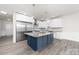 Modern kitchen features a blue island and stainless steel appliances at 17909 Wilbanks Dr, Charlotte, NC 28278