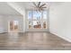 Spacious living area with large windows, hardwood floors, and a ceiling fan at 17909 Wilbanks Dr, Charlotte, NC 28278