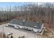 An aerial view of a commercial space featuring ample parking and lush surrounding trees at 18201 Coulter Pkwy, Cornelius, NC 28031