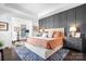 Spacious main bedroom with gray accent wall and plush bedding at 19411 Greentree Way, Cornelius, NC 28031