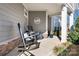 Covered porch with rocking chairs and stone base at 19411 Greentree Way, Cornelius, NC 28031