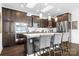 Modern kitchen with dark cabinetry, granite countertops, and stainless steel appliances at 19411 Greentree Way, Cornelius, NC 28031