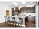 Island kitchen with dark cabinetry, granite countertops, and stainless steel appliances at 19411 Greentree Way, Cornelius, NC 28031