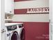 Laundry room with washer, dryer, and storage cabinets at 19411 Greentree Way, Cornelius, NC 28031