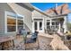 Spacious patio with seating area, brick pavement, and access to the house at 19411 Greentree Way, Cornelius, NC 28031
